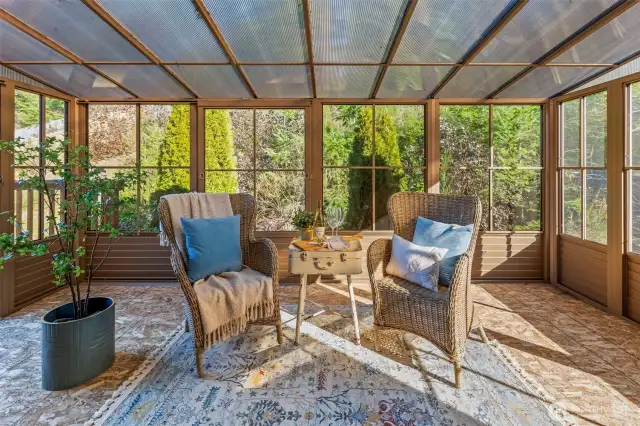 Enjoy all four seasons in this enclosed sunporch right off the primary, with deck access.