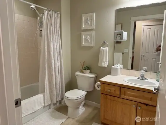 Guest bathroom with tub and shower.