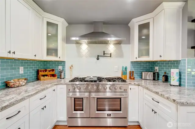 Forno range - 48 inches, 8 burners, two ovens - professional styling and performance. Pot filler, SS hood vent and tile full height backsplash.