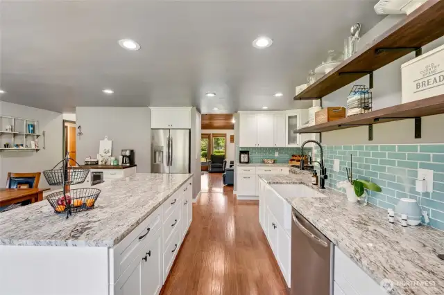 Large island with cabinetry on both sides.  Views front to back of the house. LVP flooring throughout the house. New interior doors. New windows. Four mini-splits. 25 KW generator.  New electrical panel.