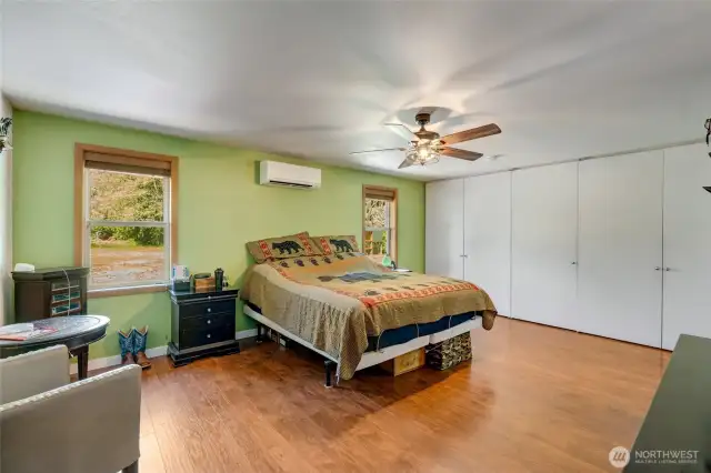 Primary bedroom. Far wall is a custom closet system that is the full length of the wall.