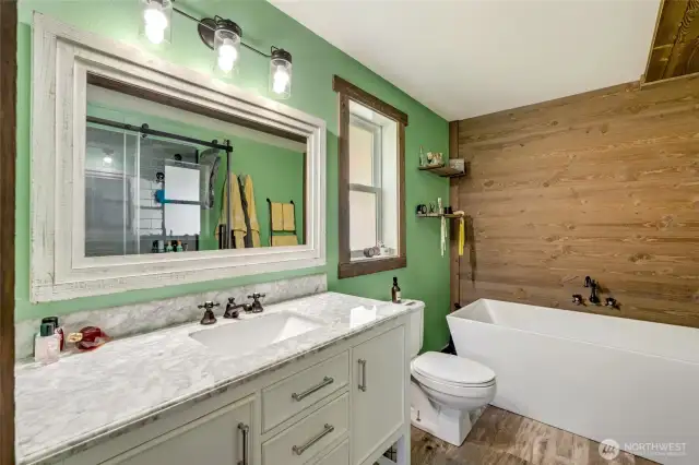 Primary 5 piece bath. Tile shower is viewed from mirror reflection.  Need a soak? This deep soaking bathtub will melt your aches away.