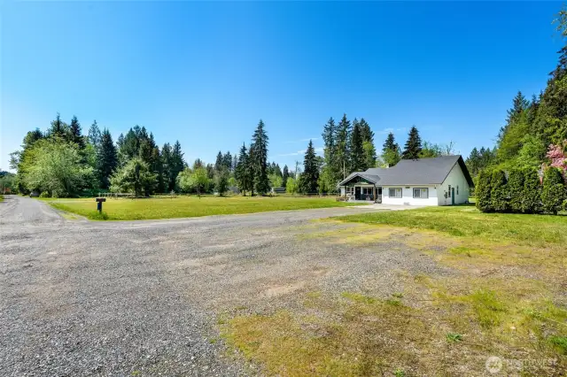 Additional parking in front. Road maintenance agreement for gravel road. Garage converted during COVID to a work/family space - garage doors are still present.