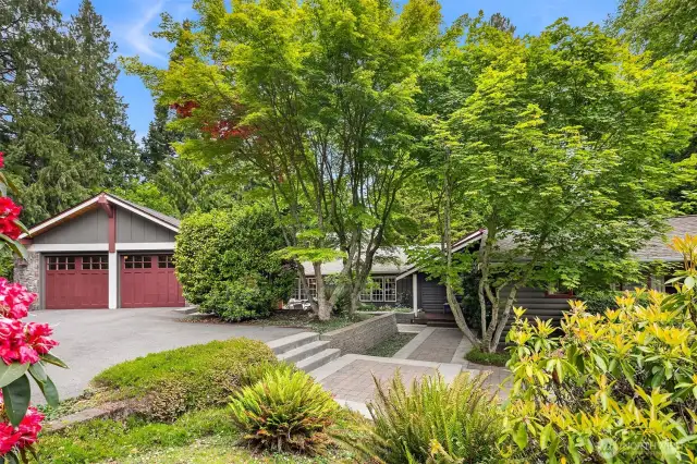 Welcome to this inviting home via a large, South-facing patio dappled with sunlight!