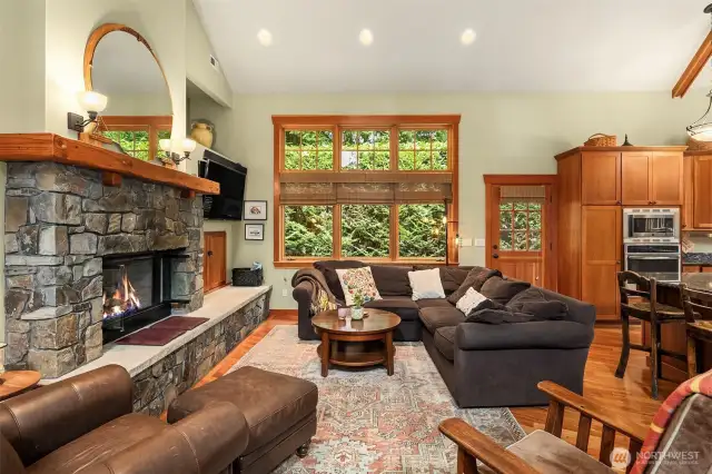 Living room with gas fireplace and windows providing ample natural light.