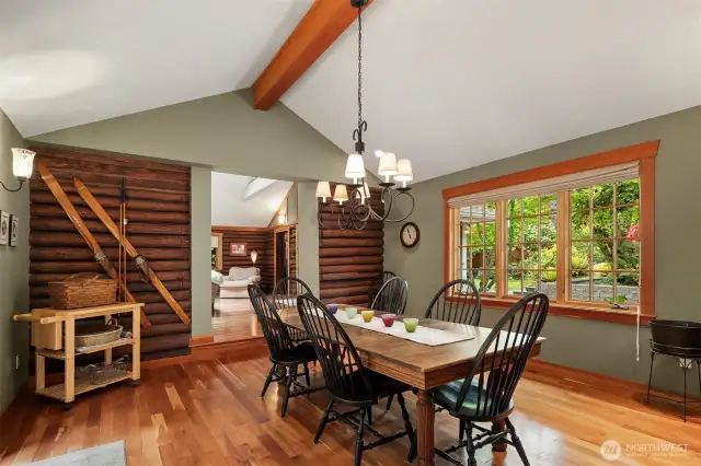 Formal dining room with large windows flowing seamlessly into living space.