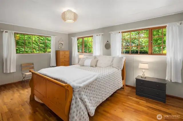 Primary bedroom with windows providing ample natural light and double closets for ample storage.