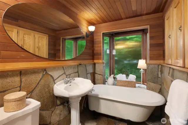 Primary full bathroom with windows providing natural light.