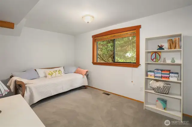 Spacious bedroom with window providing natural light.