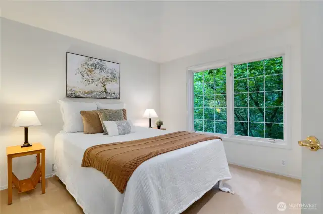 Charming first of four bedrooms on the second floor with vaulted ceiling and large picture windows offering tranquil views.