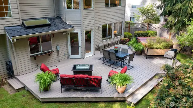 Expansive backyard deck perfect for entertaining.  Surrounded by lush landscaping for privacy and a hot tub—an ideal outdoor retreat for dining, relaxing, and gathering with friends.