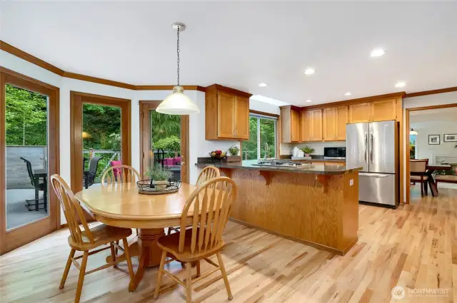 Leading from the formal dining room to the light-filled kitchen with stainless steel appliances, and abundant cabinetry. Large doors and windows connect seamlessly to the deck—perfect for indoor-outdoor dining and entertaining.