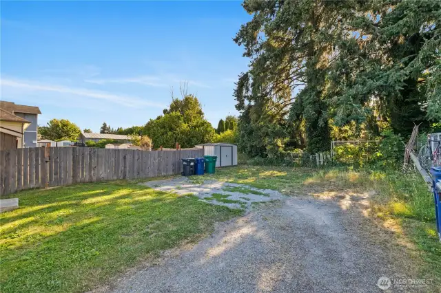 Large parking area, room for trash & recycle bins and metal storage shed for yard maintenance and/or sports or seasonal equipment