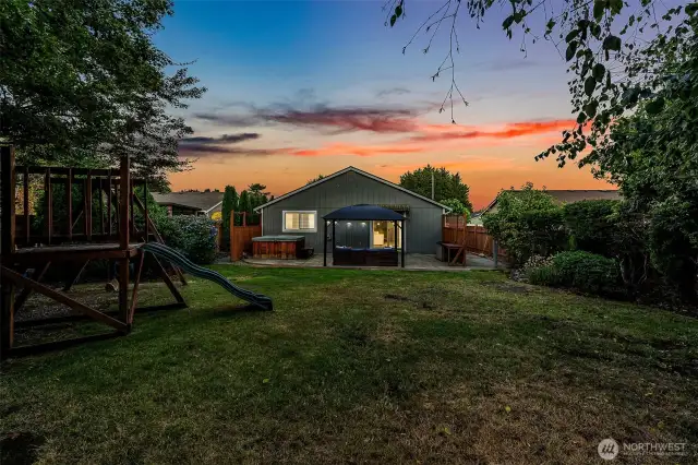 Fully fenced backyard with sprinkler system backs to a lush greenbelt for privacy and serenity.