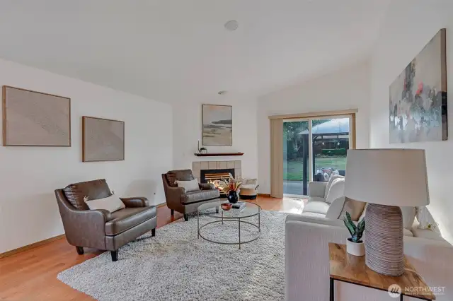 The family room boasts a cozy fireplace, continued hardwood floors and access to the patio.