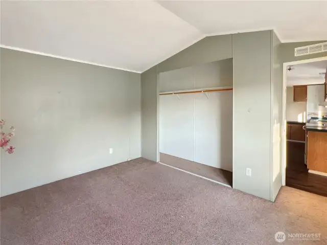 Primary bedroom with carpet.