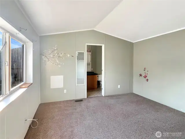Another angle of the primary bedroom offering a view into the bathroom.