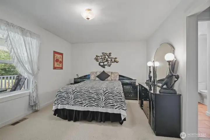Primary bedroom at front of home with walk in closet and bath