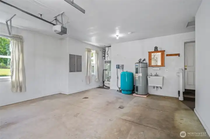 Garage interior, newer high efficiency heat pump and A/C, wash sink, entrance to home