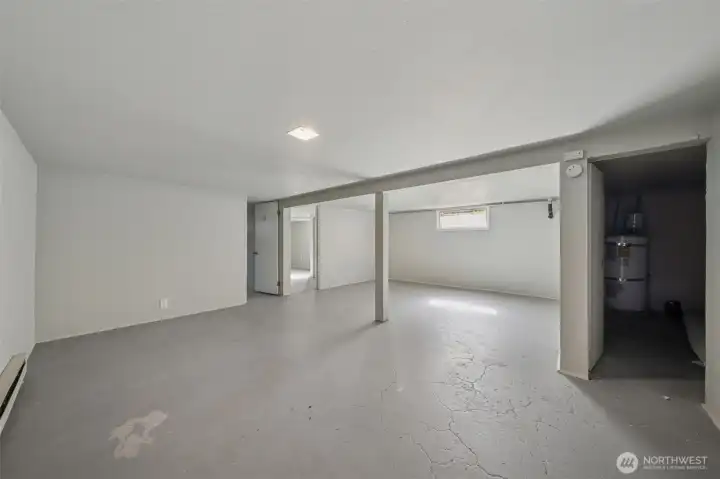 Rec room in basement - notice the additional storage room with water heater on the right.