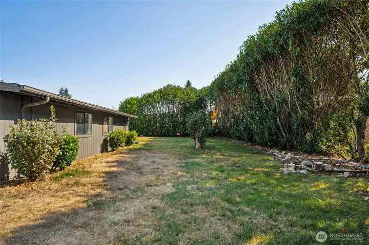 Backyard is private with garden space and plenty of room for entertaining.