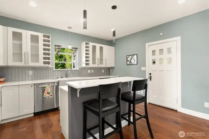 Stainless steel appliances and modern light sconces set a calming mood for your main gathering space.