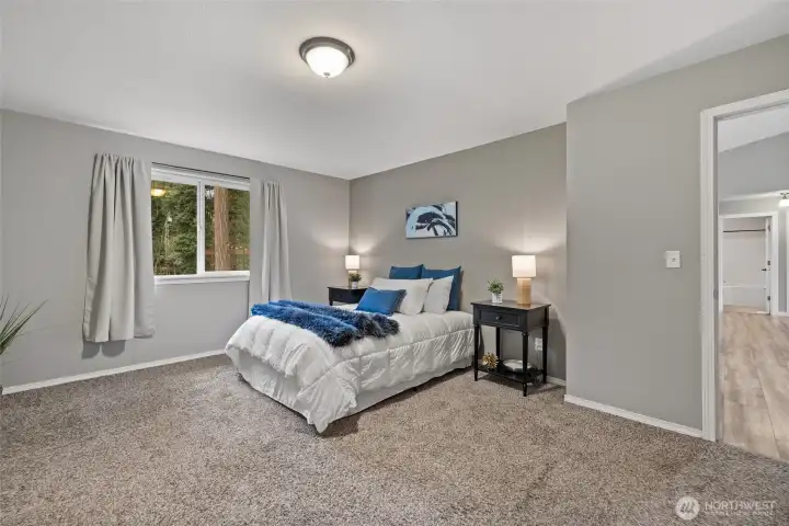 Large primary bedroom is conveniently set on one side of the house, away from the other two bedrooms