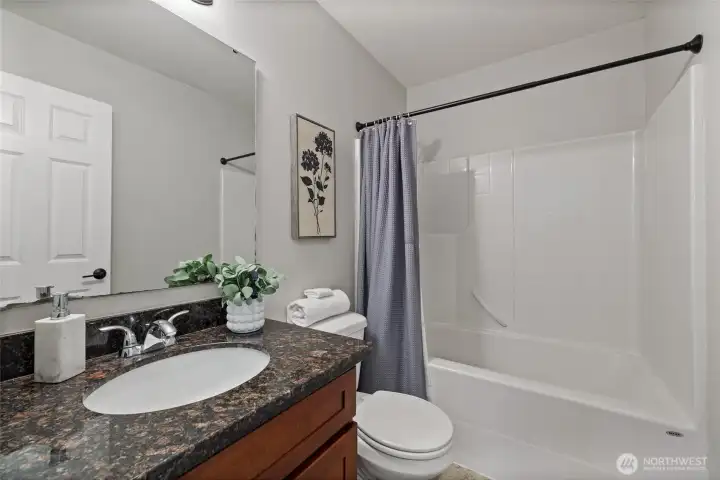 Hall full bath, conveniently situated for guests or residents