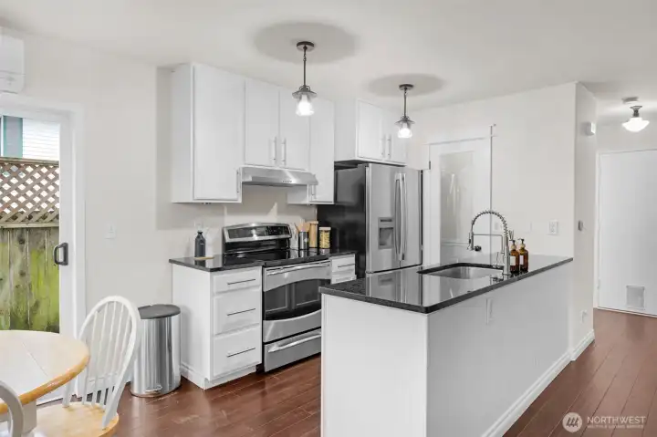 Lovely remodeled kitchen with slab granite counters, SS appliances and walk-in pantry.