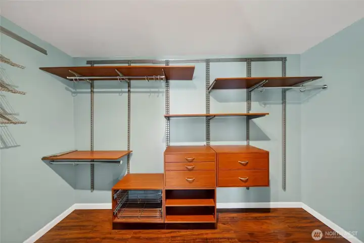 Spacious primary walk-in closet with custom built-ins for effortless organization.