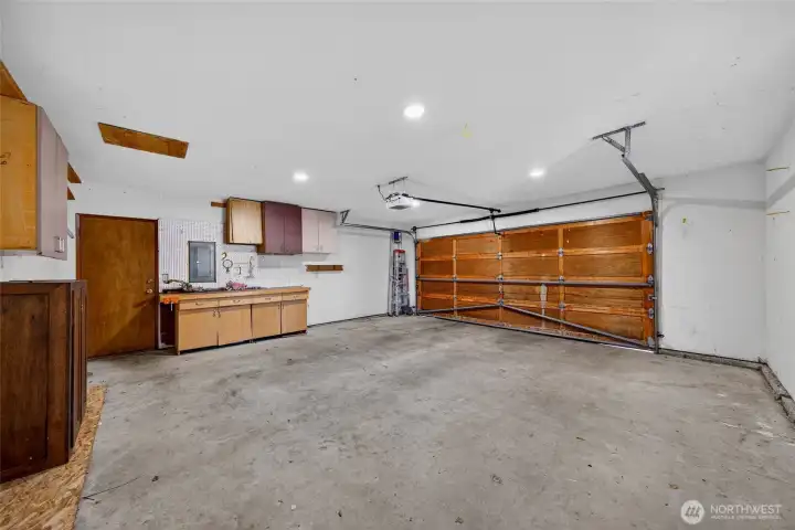 Generous garage offering extra storage space and easy side-yard access via the exterior door.
