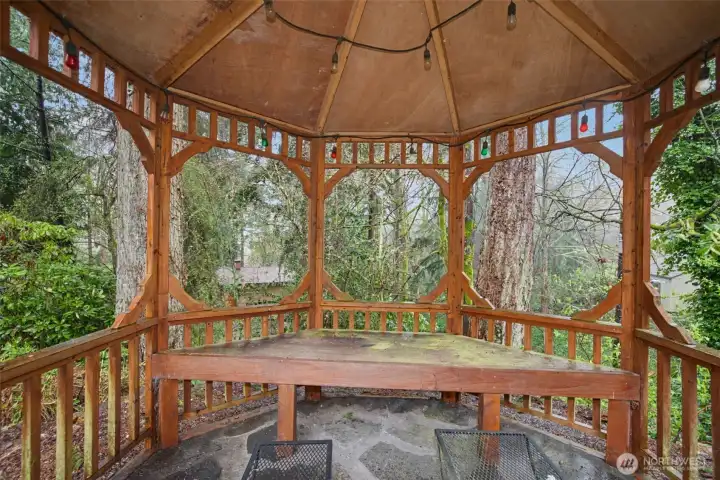 A charming gazebo, perfect for relaxing with a good book, sipping drinks with friends, or enjoying the beauty of nature in complete privacy.