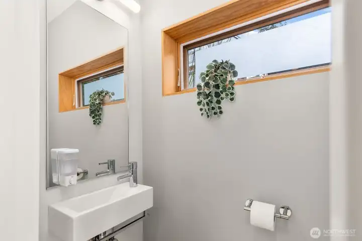 Discreetly tucked away, the main floor water closet is easily located for guests.