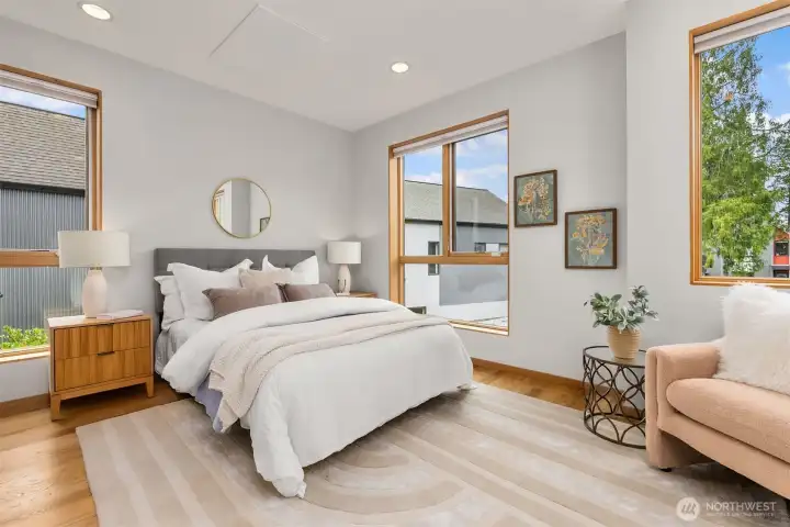 With large west and south facing windows, the first bedroom is bright and spacious with room for a desk or seating area.