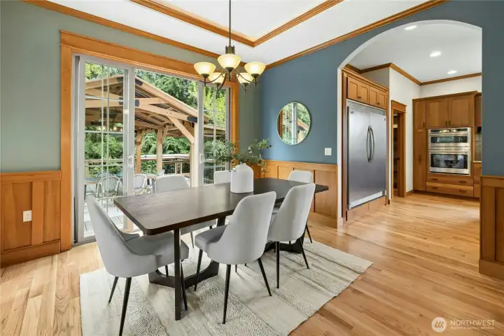On the other side of the entryway is the formal dining room. It is perfectly positioned between the kitchen and outdoor covered gazebo. Great flow for gatherings and easy entertaining.