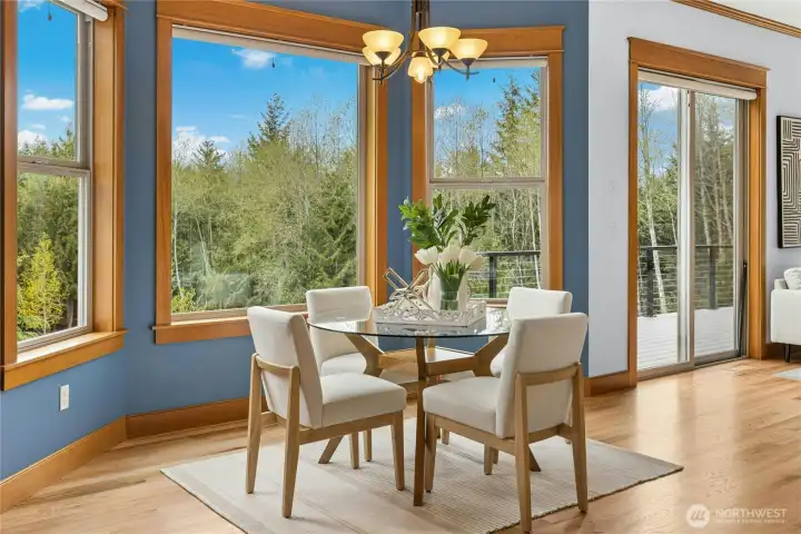 Sit at the light-filled kitchen nook or step out onto the back deck to gaze across this expansive property.
