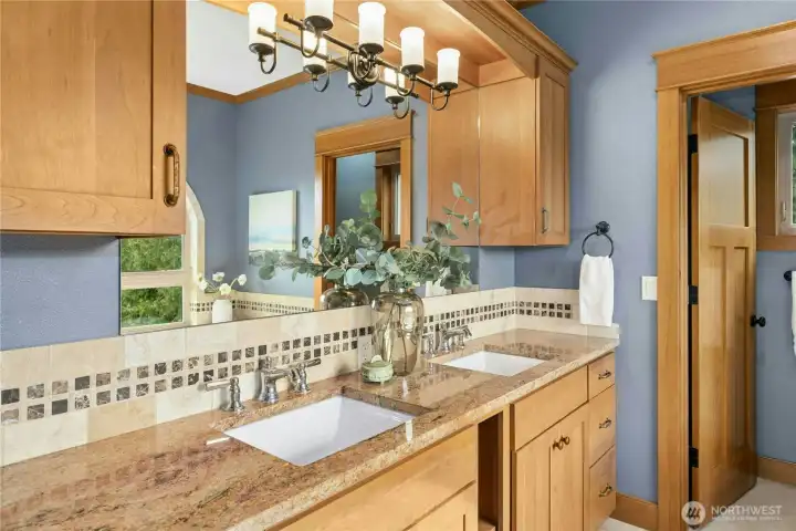 Boasting a dual vanity, water closet, soaking tub, and steam shower, the primary en suite bathroom brings spa time home.