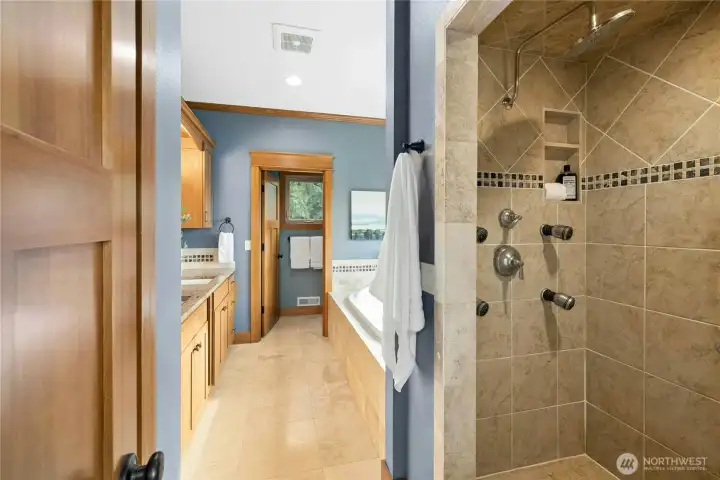 The oversized walk-in steam shower with a rain shower head.