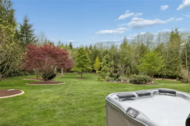 Off of the lower level is a newer Bull Frog 8-Person Hot Tub, sited perfectly to take in the park-like grounds.