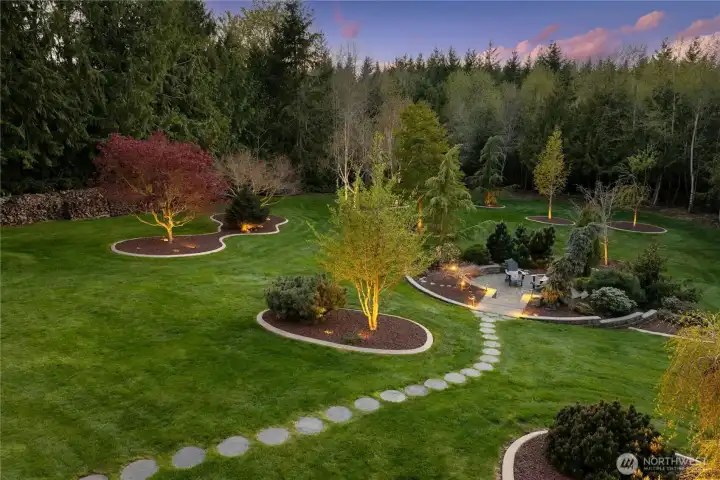 The park-like backyard is complete with a multi-station lighting system, irrigation system, and carefully chosen plantings for a truly magical setting.