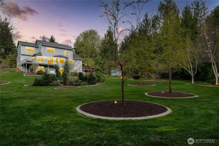 Artful landscape lighting creates a peaceful atmosphere for evening strolls, pets, lawn games, or your next big get-together.