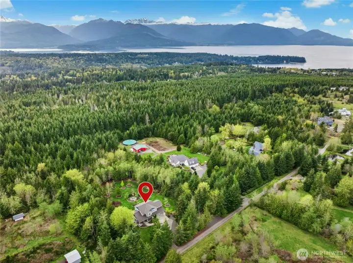 An aerial view of the home, property and adjacent state land behind the home.
