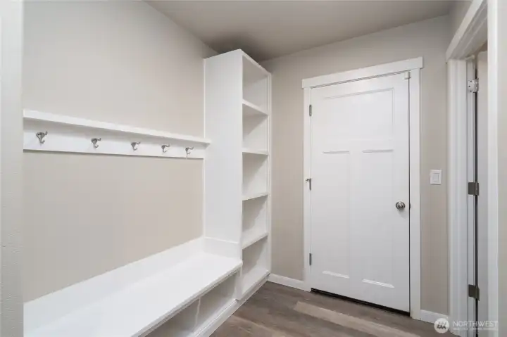 Smartly organized mud room with hooks and storage for shoes and backpacks