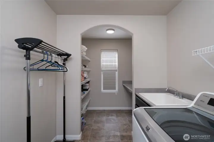 Laundry adjacent to Primary bedroom and access from hallway, room for a hanging rack