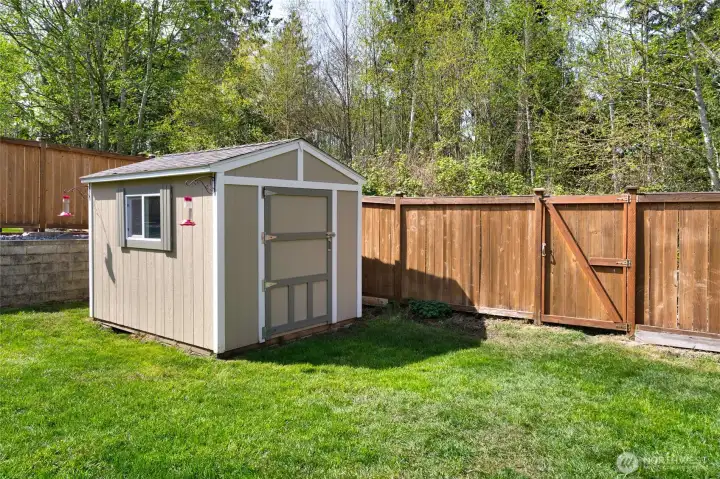 Storage shed that architecturally matches the house, gate is to access greenbelt