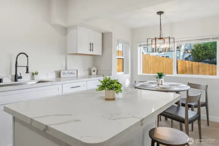 The heart of the home. A light-filled kitchen with quartz counters, stainless appliances, and an island made for morning coffee and evening conversations.