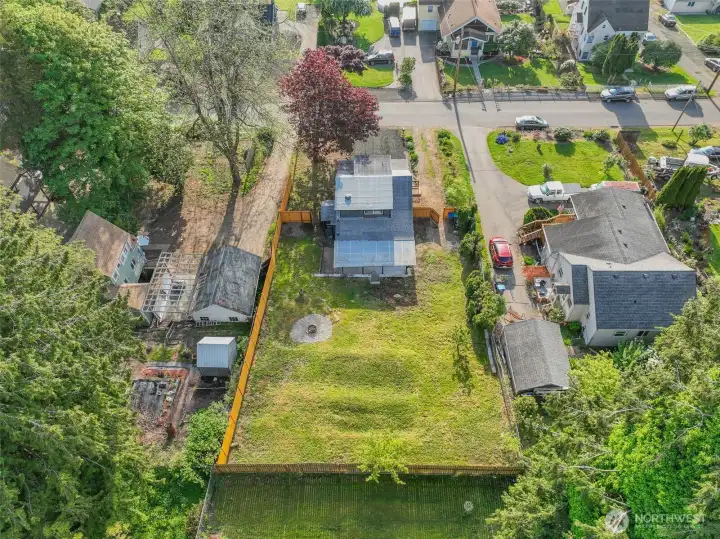 Nearly a quarter acre of fully fenced outdoor space ready for whatever you envision. Garden, gather, or unwind year round under the covered patio.