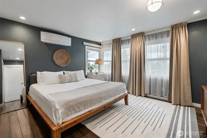 Master bedroom with two closets and large windows.