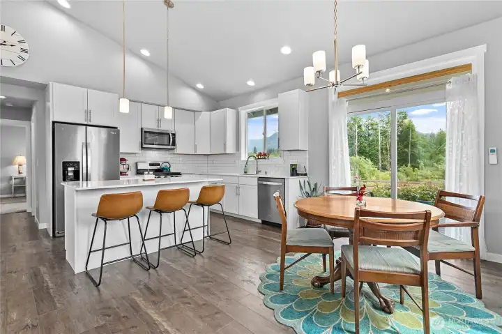 Informal seating and dining space off of kitchen and steps away from the covered back patio.