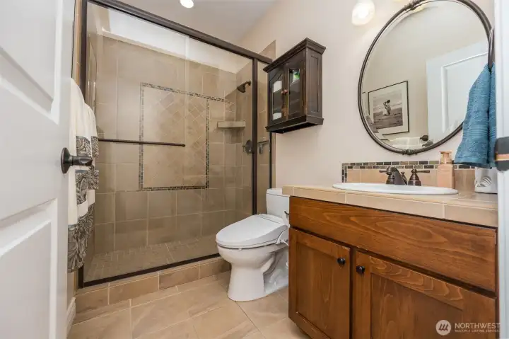 Downstairs bathroom with tile floors, shower and counter tops, bidet toilet and off from the guest bedroom on main floor Downstairs bathroom with tile floors, shower and counter tops, bidet toilet and off from the guest bedroom on main floor